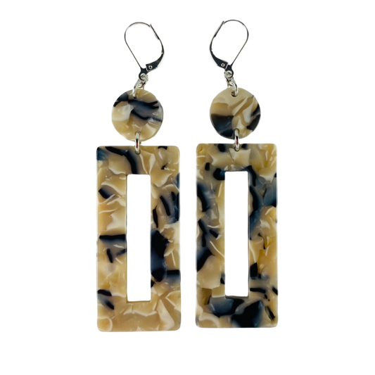 Dangling earring with two geometric shaped beads. One dime shaped and one donut shaped rectangle.  Marbled beige, midnight blue and white.