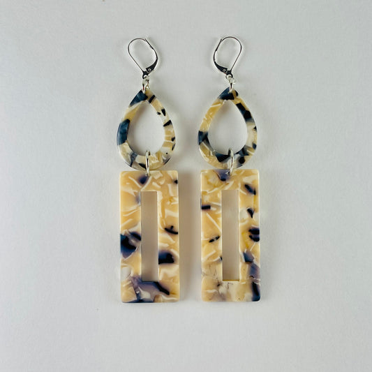 Dangling earring with 2 geometric shaped beads. Marbled beige, midnight blue and white.  A teardrop and a rectangle.
