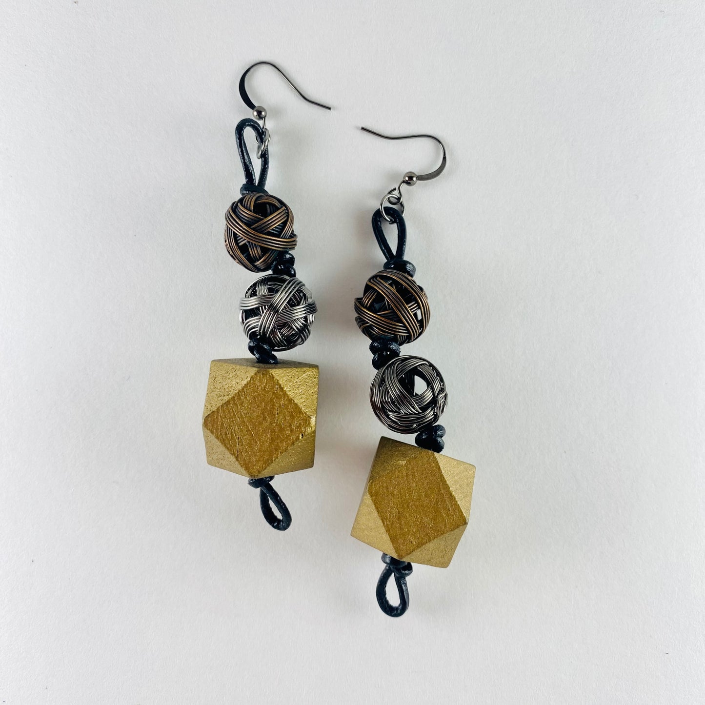 Dangling earrings with 3 geometric beads.  Two small wire spheres and one multi-faceted wooden spheres.