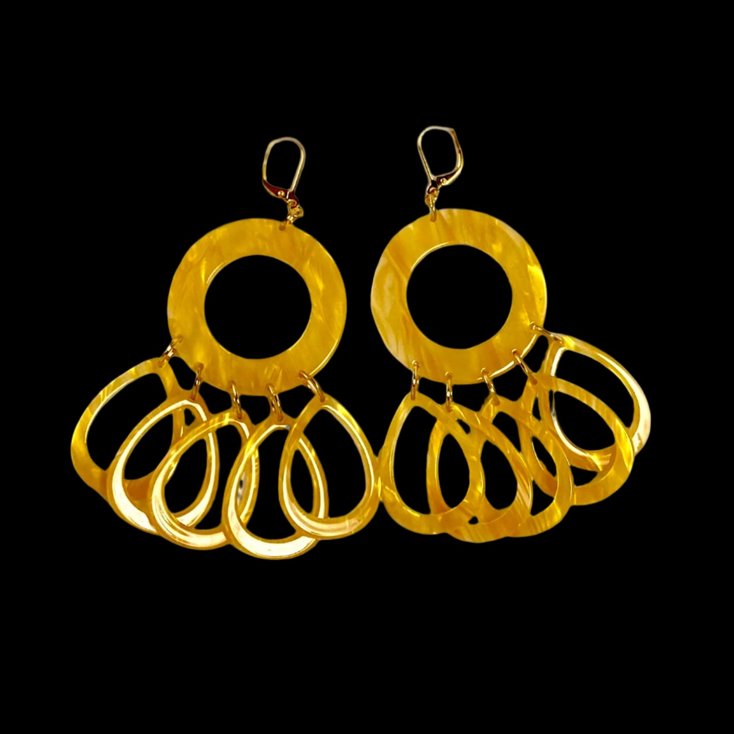 Dangling earring.  Honey yellow  donut shaped bead with five individual dangling acetate teardrop beads.