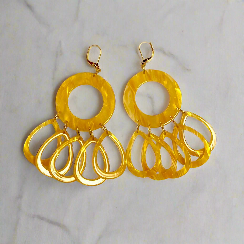 Dangling earring.  Honey yellow  donut shaped bead with five individual dangling acetate teardrop beads.