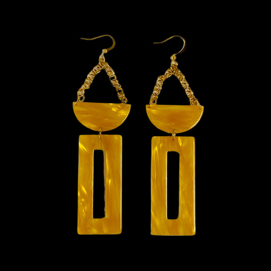 Acetate, dangling earrings attached by gold chain to a half moon shaped bead and an open rctangle bead.